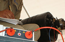 An employee performing an electrical test on a rotor. Click here to continue to the Generator Testing page.